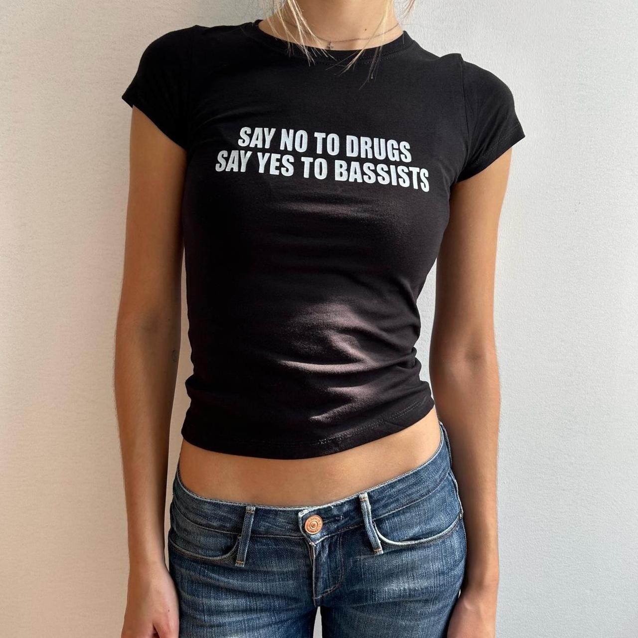 Model wearing black baby tee with "Say No to Drugs Say Yes to Bassists" written in white across the chest.