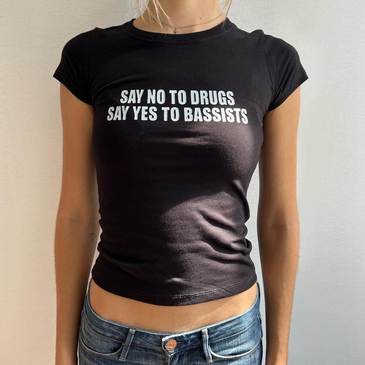 Model wearing black baby tee with "Say No to Drugs Say Yes to Bassists" written in white across the chest.