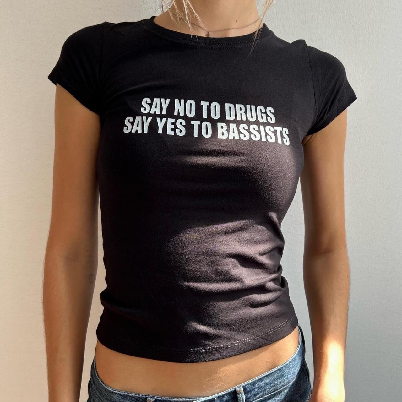 Model wearing black baby tee with "Say No to Drugs Say Yes to Bassists" written in white across the chest.