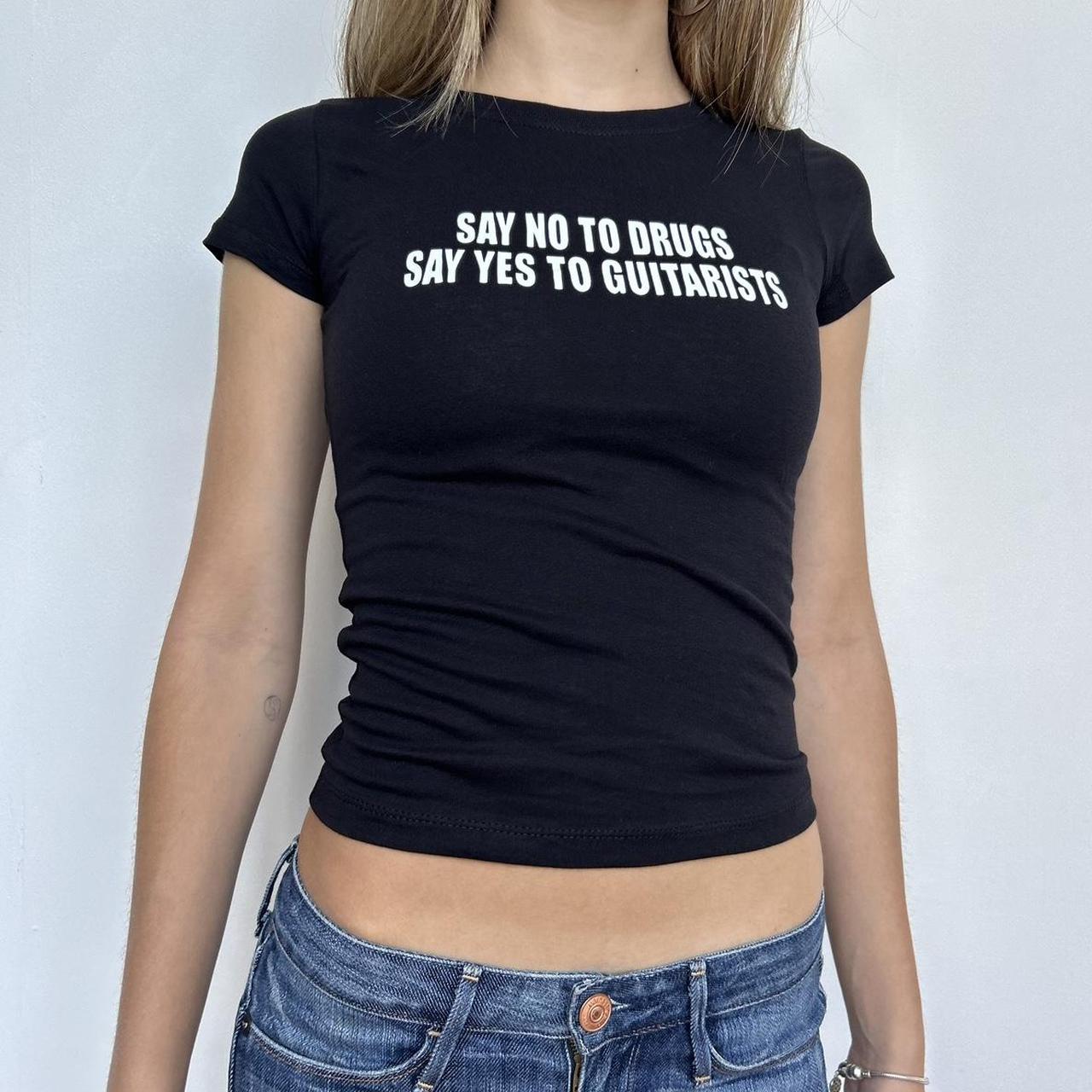 Model wearing black baby tee with "Say No to Drugs Say Yes to Guitarists" written in white across the chest.