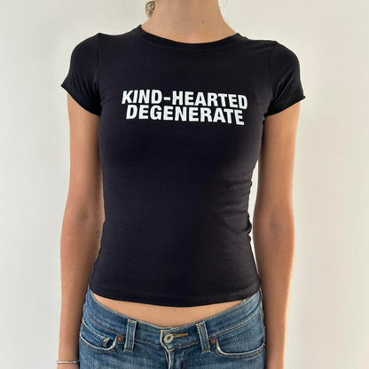 Model wearing black baby tee with "Kind-Hearted Degenerate" written in white across the chest.