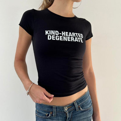 Model wearing black baby tee with "Kind-Hearted Degenerate" written in white across the chest.